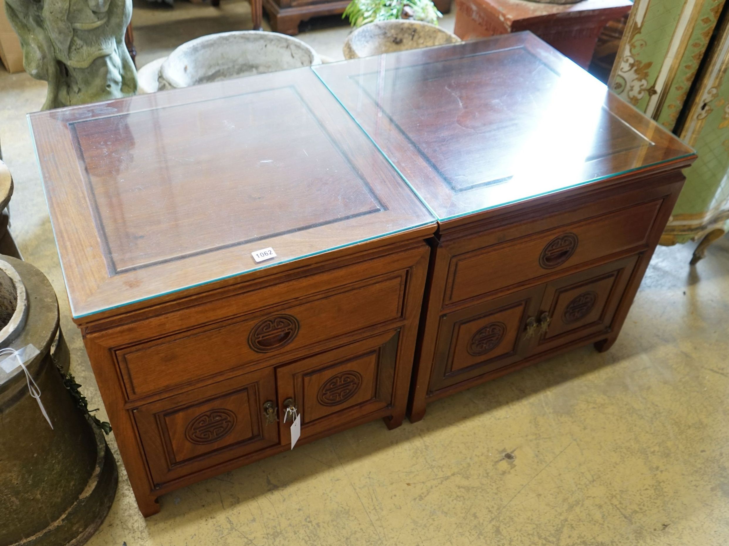 A pair of Chinese carved hardwood low cabinets, width 56cm, depth 56cm, height 56cm